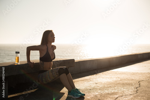 Fit woman doing exercices on summer sunset