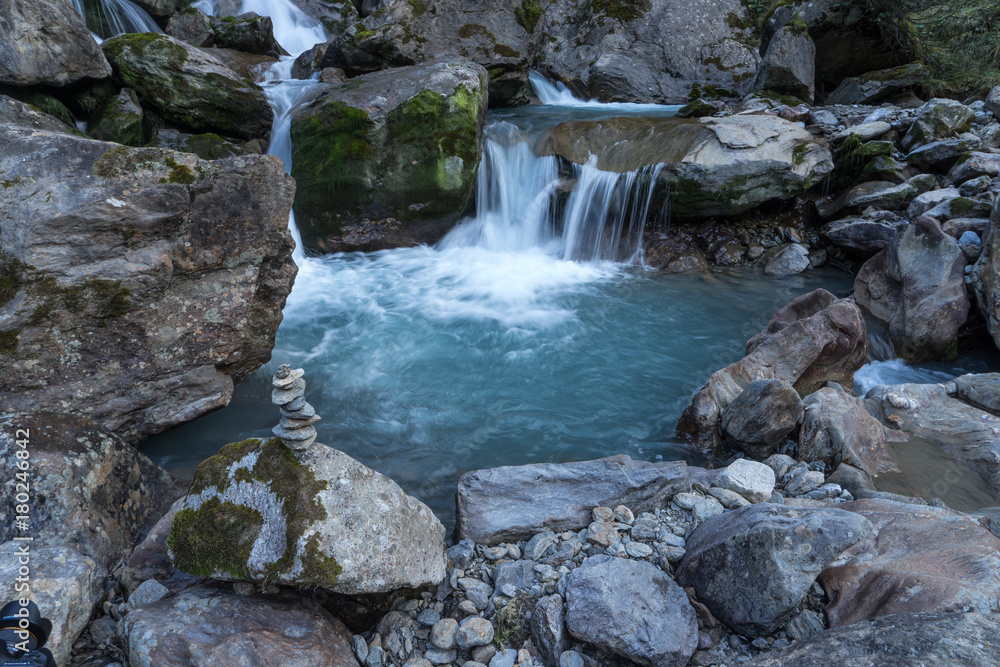 Mountain river and stones landscape natural environment. Hiking in the alps. Grawa Waterfall in Stubai Valley, Tyrol, Austria Mountain river and stones landscape natural environment. Hiking in the alps. Grawa Waterfall in Stubai Valley, Tyrol, Austria