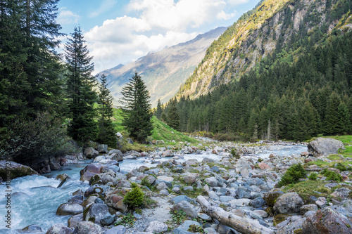 Mountain river and trees landscape natural environment. Hiking in the alps. Grawa Waterfall in Stubai Valley, Tyrol, Austria