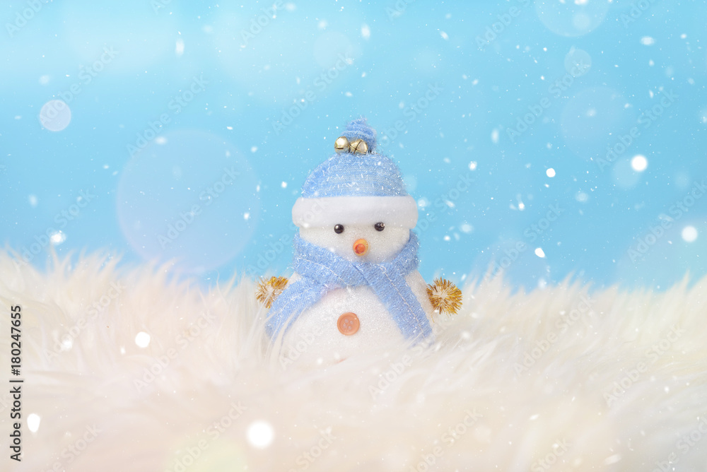Happy snowman standing in blue winter christmas snow background. Merry christmas and happy new year greeting card with copy-space. Christmas celebration holiday background.