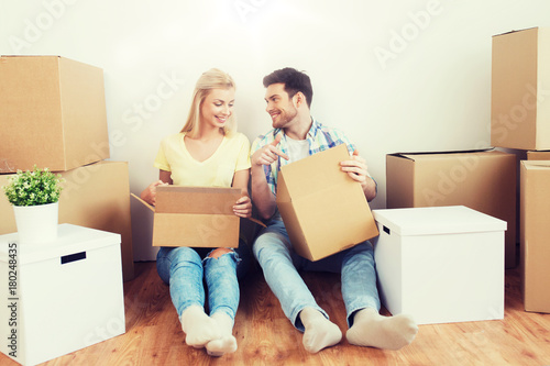 smiling couple with many boxes moving to new home © Syda Productions