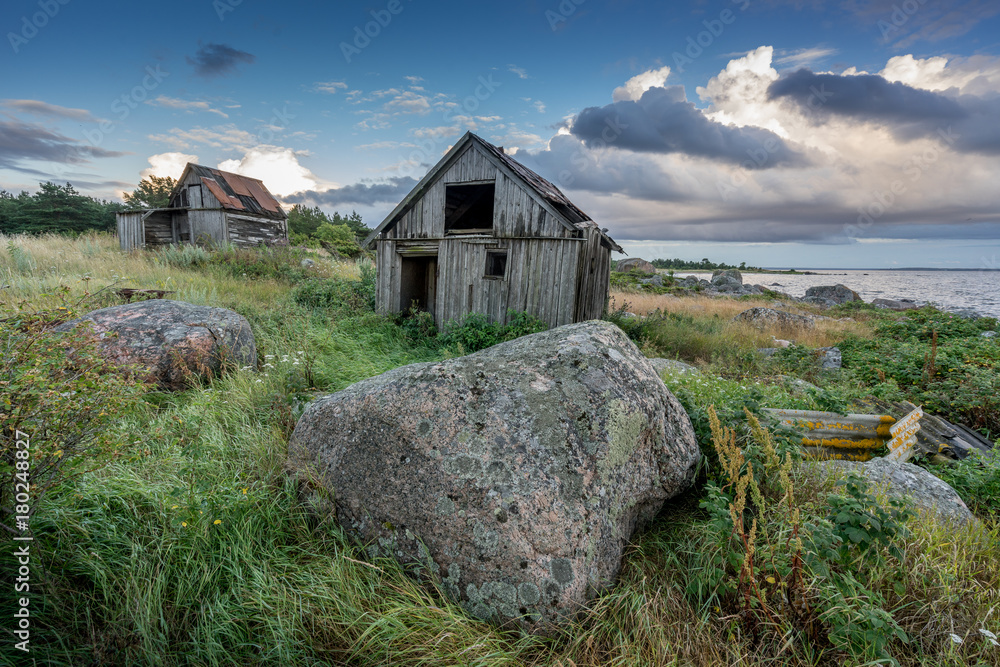 Abandoned houses in the Baltic Sea. Shore, nature and ruins facilities architecture concept. Mohni, small island in Estonia, Europe.