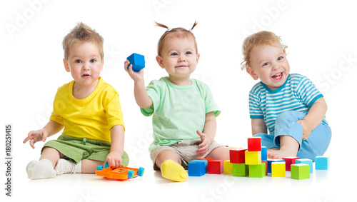 Funny children group playing colorful toys isolated on white