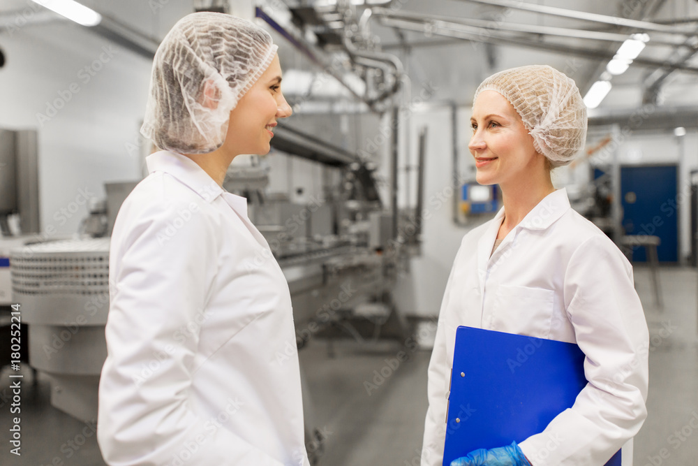 happy women technologists at ice cream factory happy women technologists at ice cream factory