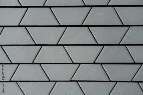 Close-up of decorative ceramic white brick wall in trapezoid pattern