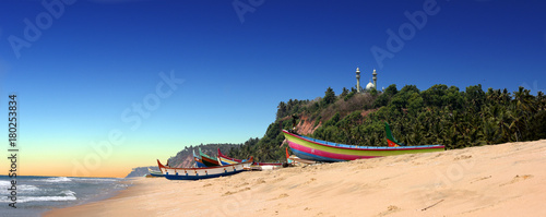 Obraz na płótnie panoramic view of colorful fishermen boats in front of Varkala South Cliff with