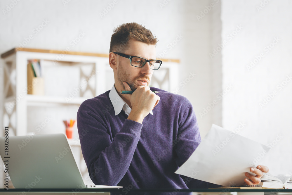 Thoughtful european businessman working on project Thoughtful european businessman working on project