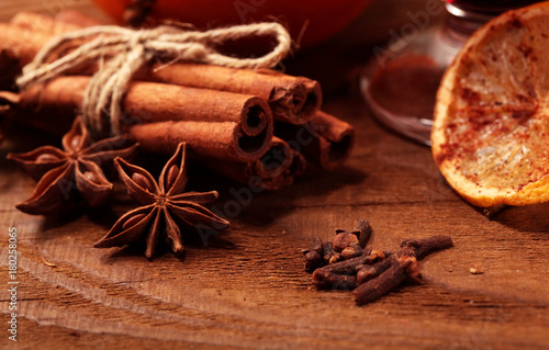 cinnamon stick and star anise spice on wooden background macro.