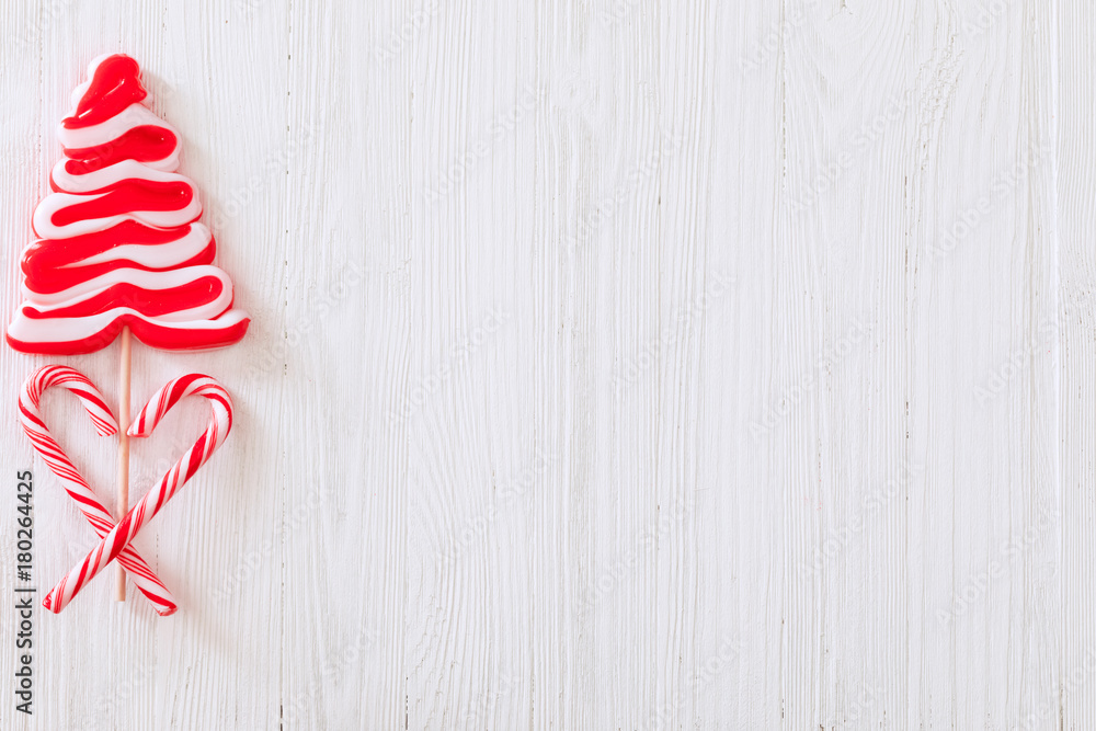 Christmas candy cane lollipop Christmas tree over white wooden textured background Christmas candy cane lollipop Christmas tree over white wooden textured background