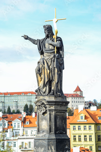 Prague, Czech Republic - October 9, 2017: Statue of John the Baptist, installed on the north side of the Charles Bridge in Prague, Czech Republic.