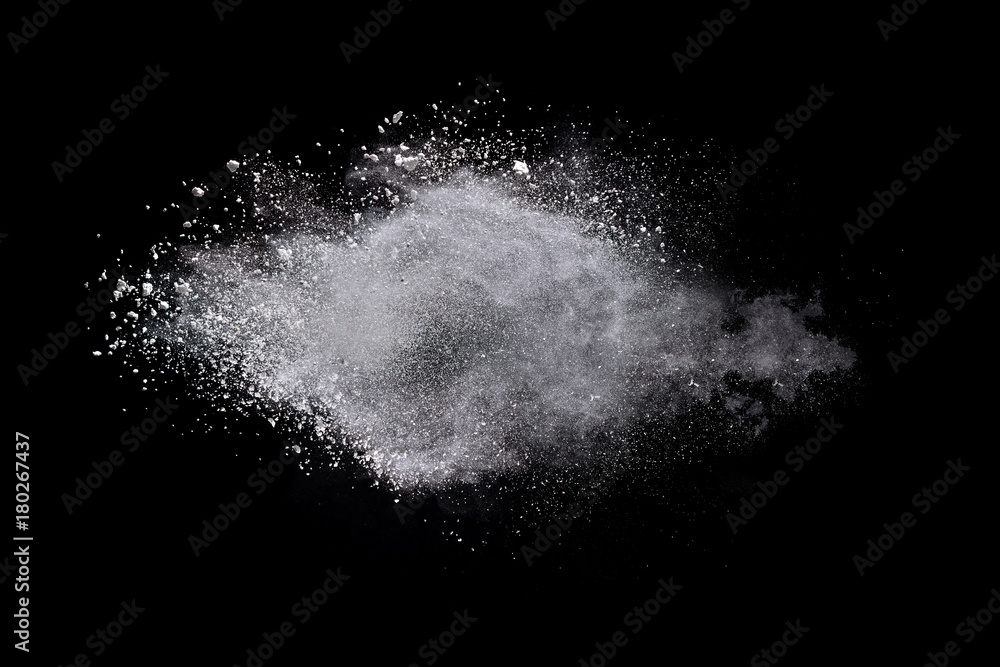 Freeze motion of white powder explosions isolated on black background