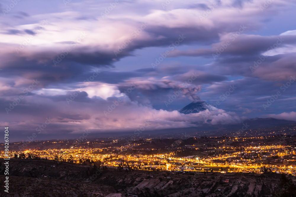 Obraz premium Clouds and ash of the Cotopaxi volcano is dramatically mixed at dusk