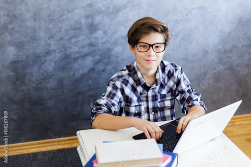 Teenage boy working on lapt...