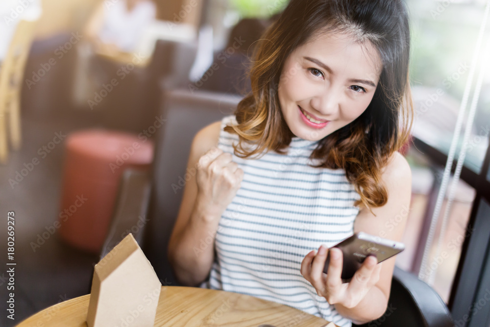 asian girl with happiness emotion with result from smarthphone display business success ideas concept asian girl with happiness emotion with result from smarthphone display business success ideas concept