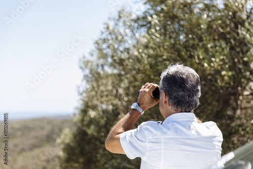 Man watching with binoculars