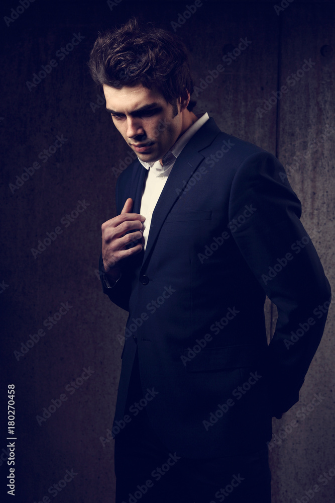 Handsome attractive male checks time, hurries for business meeting, looks  at watch, dressed in formal black suit, poses outdoor near office building  Stock Photo - Alamy
