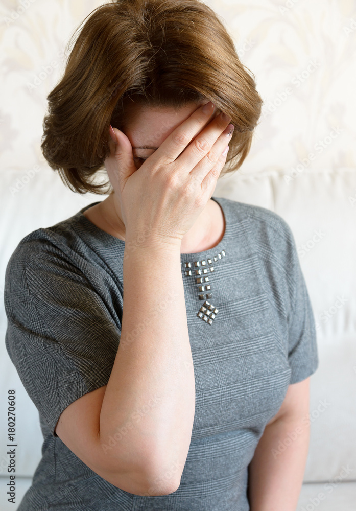 Woman covering her face with her hand. Depression Woman covering her face with her hand. Depression