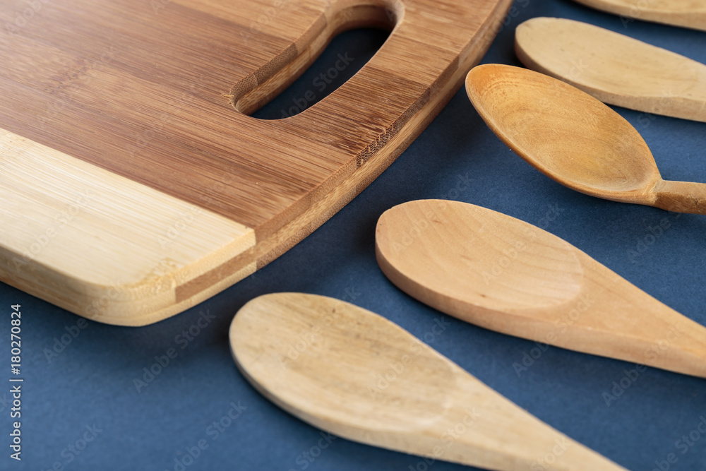 kitchen cutting board and a wooden spoon on a blue