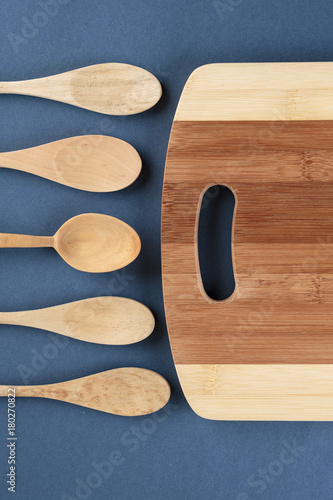 kitchen cutting board and a wooden spoon on a blue