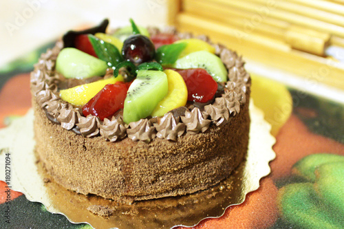 small chocolate cake with different, fresh fruit