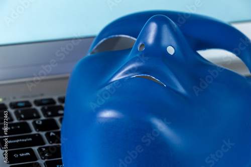 Identity on Social Networks concept. Blue mask on computer keyboard