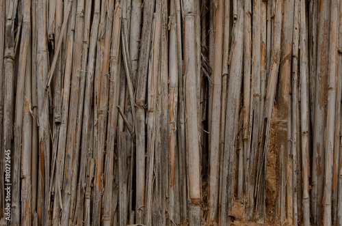 dry cane and clay texture of a mud hut of a structure brown close up