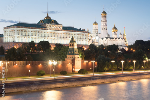 The bell tower of Ivan the Great and the Annunciation Cathedral in the Moscow Kremlin. Grand palace and brick red wall with towers
