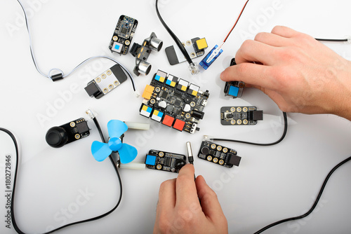 Man connecting different electrical boards photo
