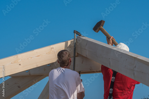 Roofers make the roof of a house in traditional construction