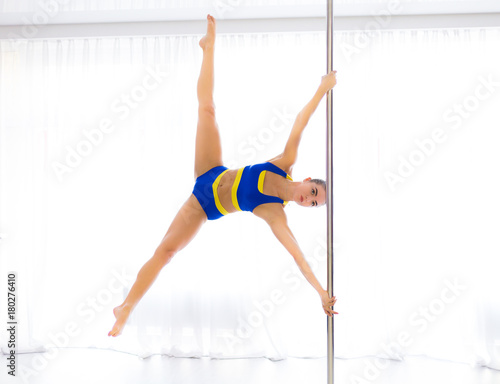 Young pole dancer in the studio