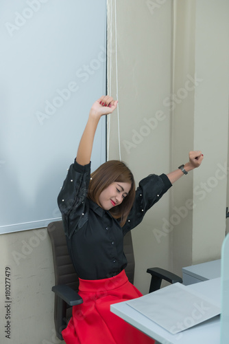 Fototapeta Naklejka Na Ścianę i Meble -  Asian businesswoman stretching body on the chair,Clerk working in the office,Fatigue from work