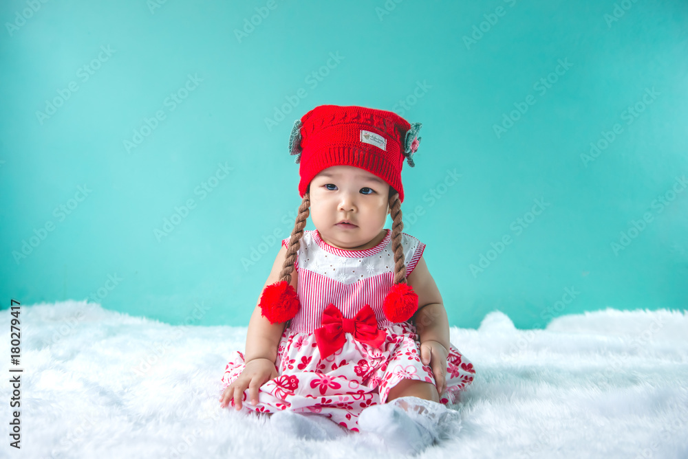 Portrait of cute asian baby in pink dress on carpet wool,happy baby concept,smile,thail little baby Portrait of cute asian baby in pink dress on carpet wool,happy baby concept,smile,thail little baby