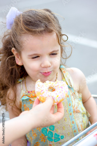 Little girl eating a donut