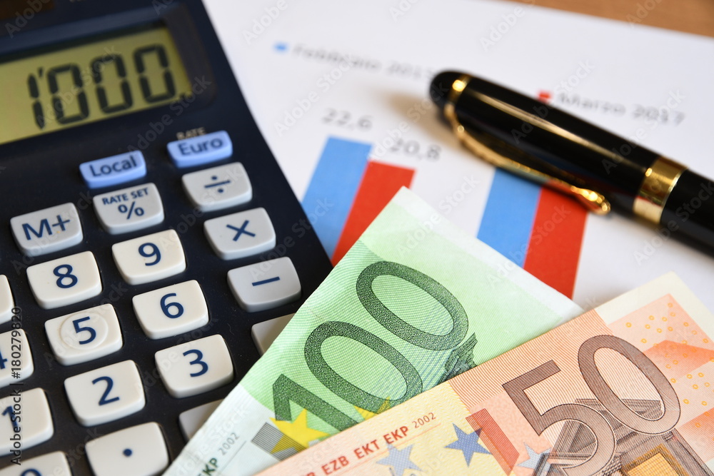 Euro banknotes with calculator, pen, glasses and paperwork. Business concept image. Euro banknotes with calculator, pen, glasses and paperwork. Business concept image.