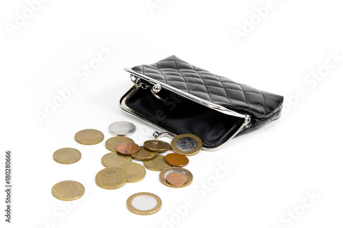 Coins from the old wallet on a white background. Vintage empty purse. The concept of poverty in retirement.