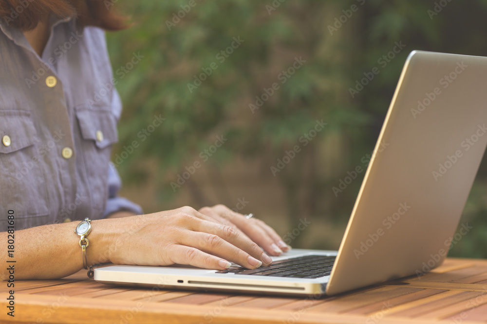 Woman working on laptop computer while outside Woman working on laptop computer while outside