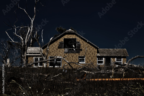 Spooky old abandoned house in a Kansas corn field at night