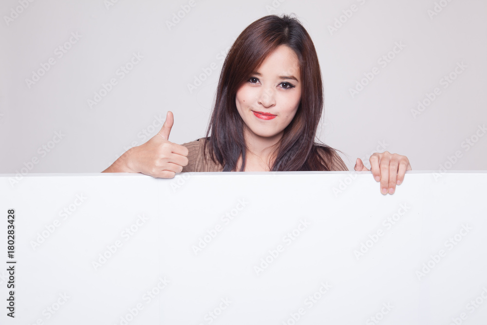 Young Asian woman show thumbs up with blank sign. Young Asian woman show thumbs up with blank sign.