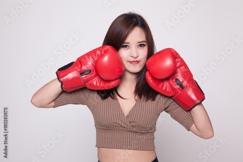Young Asian woman with red boxing gloves.