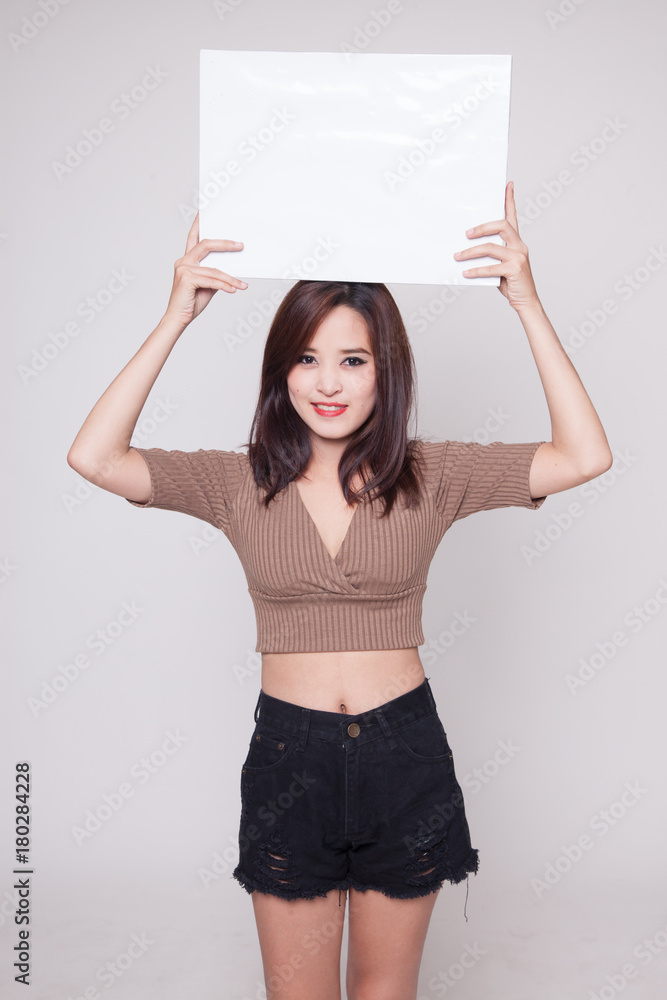 Young Asian woman with white blank sign. Young Asian woman with white blank sign.
