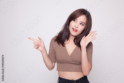 Excited Asian woman point to blank space.