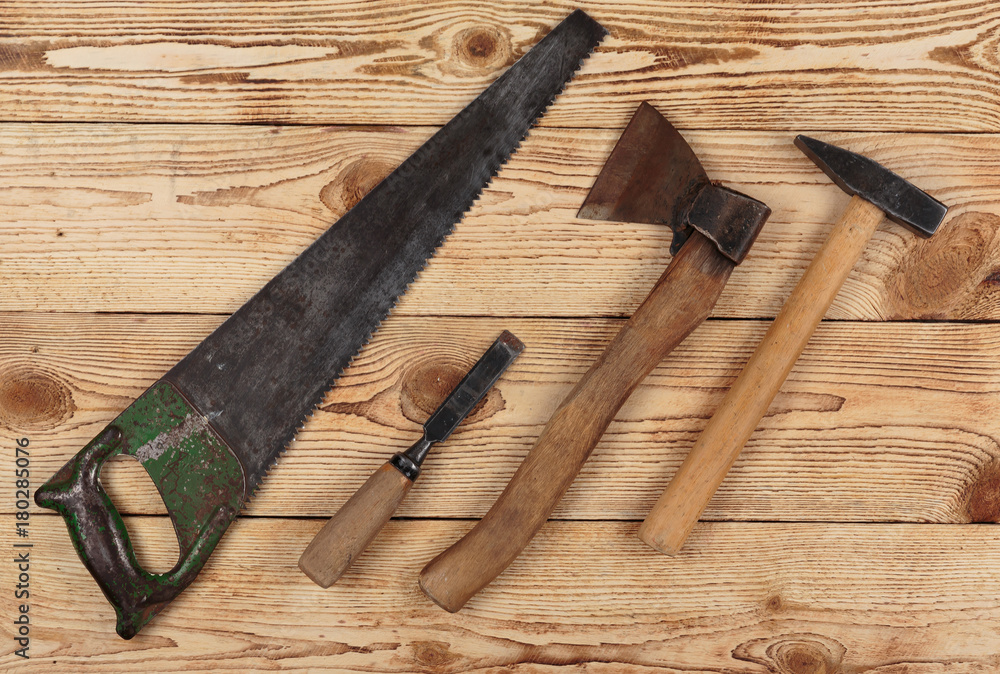 Old carpentry tools on a wooden background