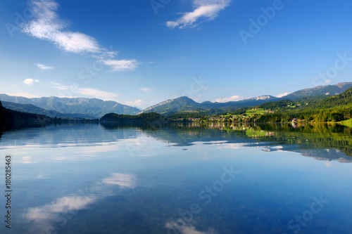 Scenic view of picturesque reflections in calm waters of Hallstatt lake or Hallstatter See  Austria
