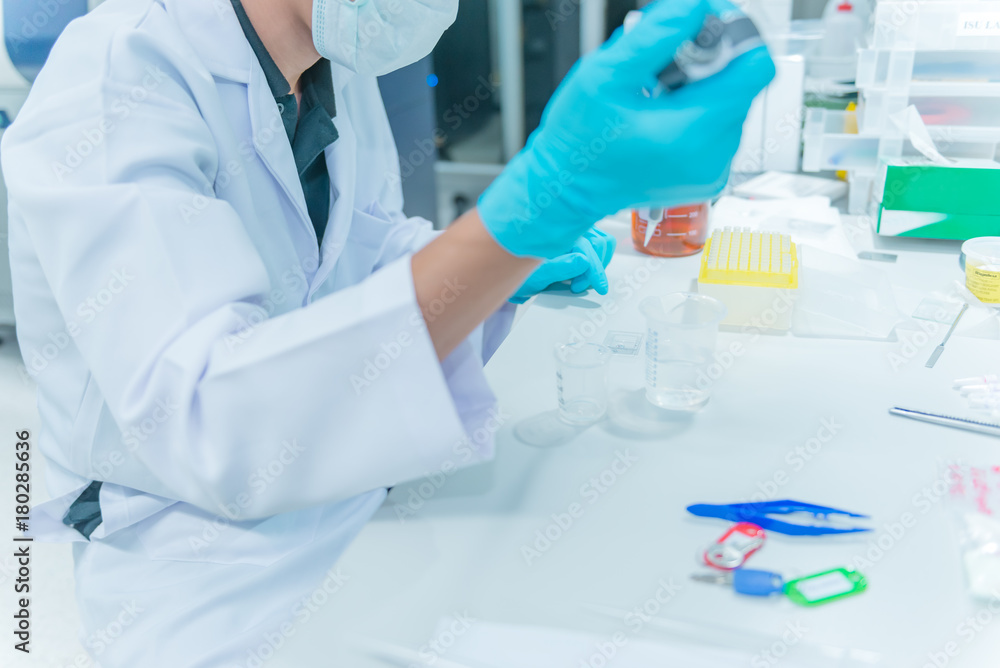 Fototapeta premium The scientists injected chemicals into plastic tubes,Suientist working in the lap