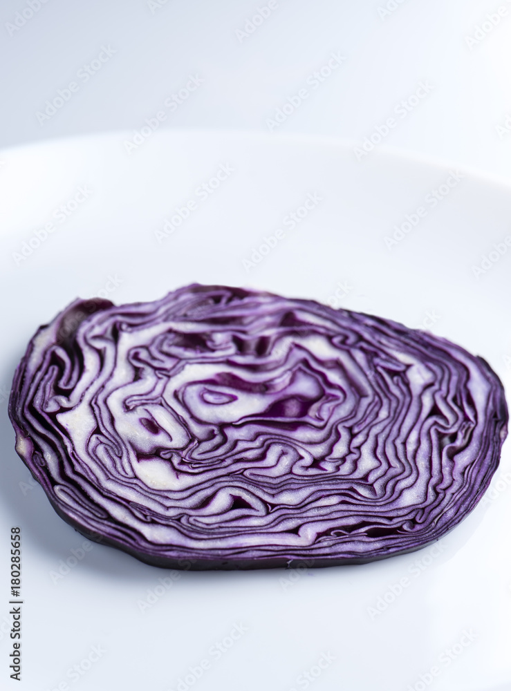 Obraz premium Cut of red cabbage on the white plate