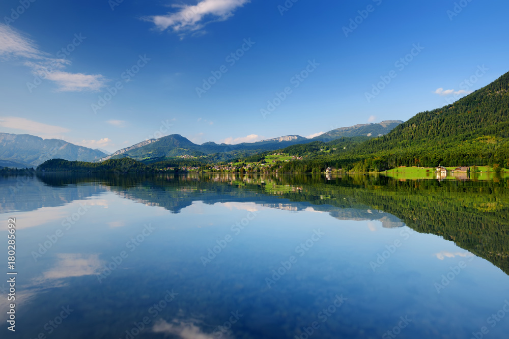 Scenic view of picturesque reflections in calm waters of Hallstatt lake or Hallstatter See, Austria