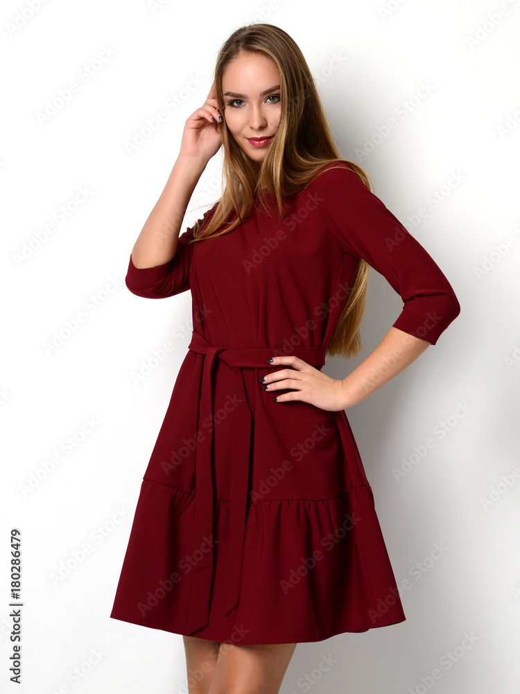 Young beautiful woman posing in new fashion red pattern winter dress