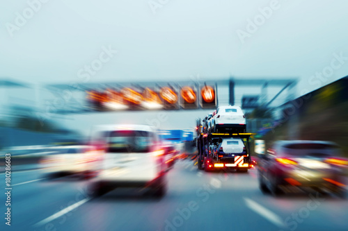 Lorry with new cars driving on motorway