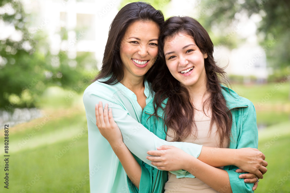 Fototapeta premium Asian mother laughing and huging her child.