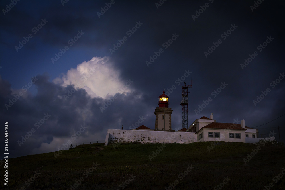 Dramatic night Portuguese landscape on the coast of Atlantic Ocean, the westernmost point of mainland Europe  at Cabo da Roca. Old  Lighthouse.